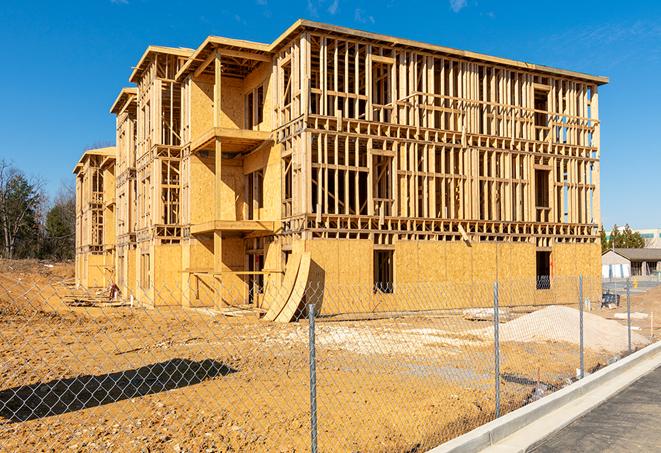 a temporary chain link fence winding around a construction site, outlining the project's progress in Lomita, CA